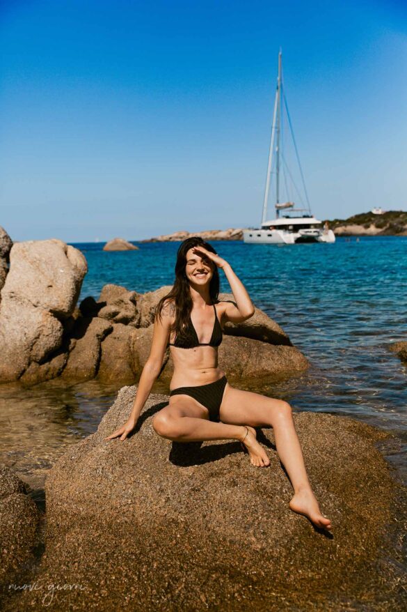 Girl sunbathing on a rock in Tivella beach Corsica France Nuovi Giorni Blog